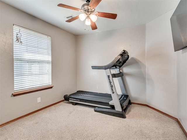 exercise area with ceiling fan and carpet