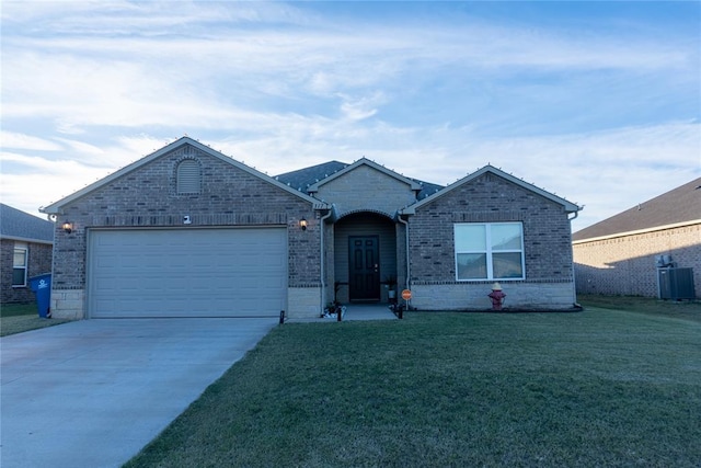 ranch-style home featuring cooling unit, a front yard, and a garage