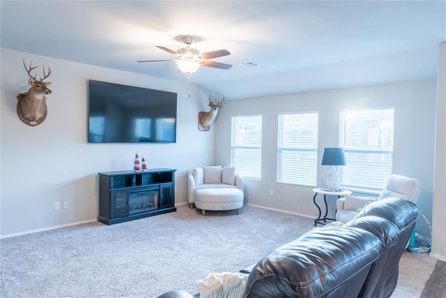 carpeted living room with ceiling fan