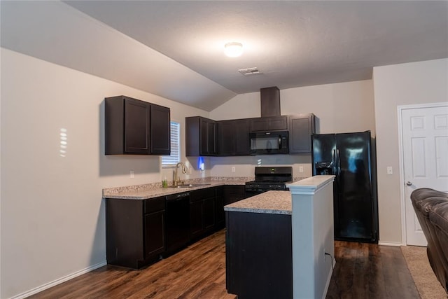 kitchen featuring dark wood-type flooring, a center island, black appliances, and lofted ceiling