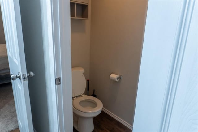 bathroom featuring wood-type flooring and toilet