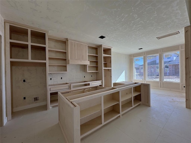 kitchen with backsplash and a textured ceiling