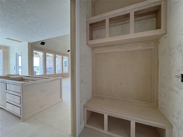 mudroom featuring a textured ceiling