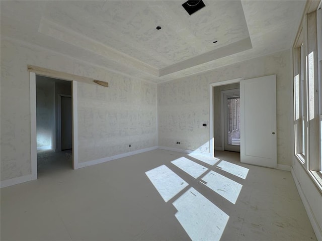 unfurnished room with a tray ceiling