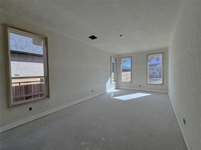 empty room with concrete flooring