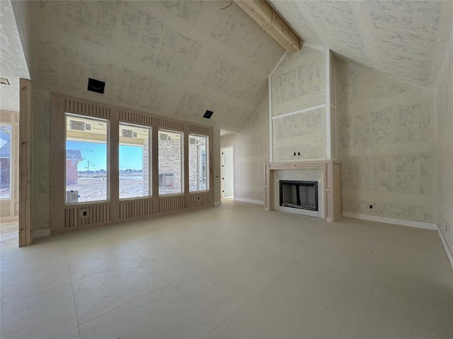 unfurnished living room featuring beam ceiling and high vaulted ceiling