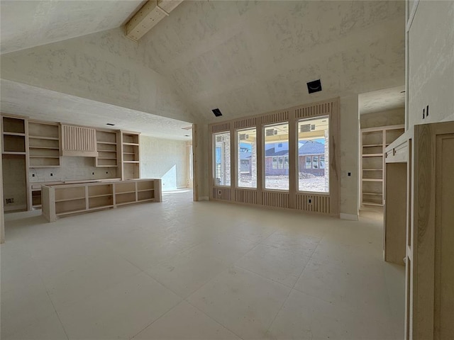 unfurnished living room featuring high vaulted ceiling and beam ceiling