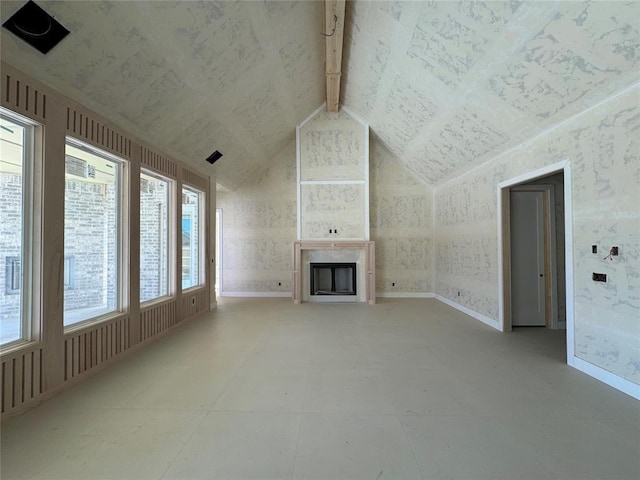 unfurnished living room featuring vaulted ceiling with beams