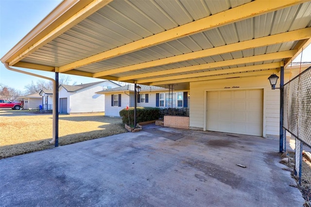 view of patio featuring a carport and a garage