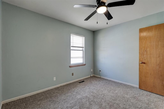 carpeted spare room with ceiling fan