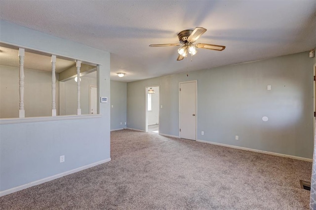 spare room with ceiling fan, carpet floors, and a textured ceiling