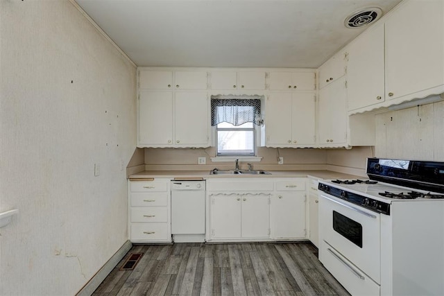 kitchen featuring white appliances, hardwood / wood-style flooring, white cabinetry, and sink