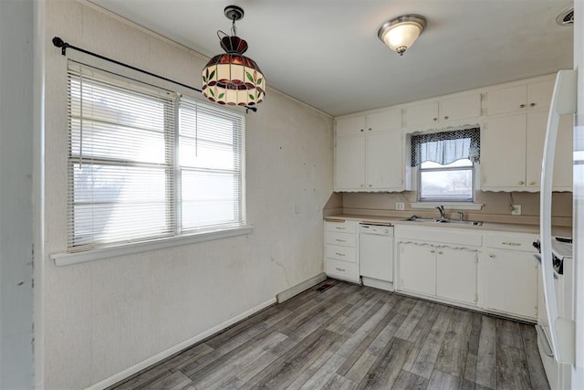 kitchen with white cabinets, pendant lighting, white dishwasher, and sink