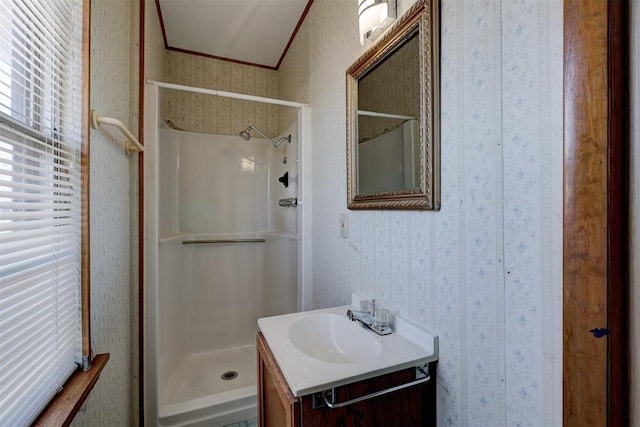 bathroom featuring vanity, walk in shower, and ornamental molding