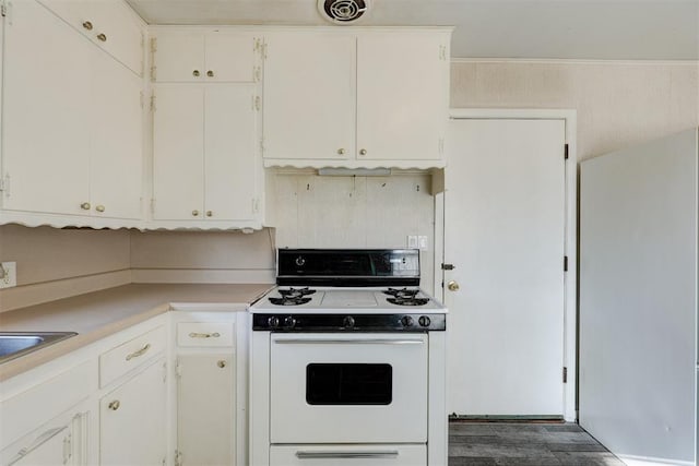 kitchen featuring white appliances and white cabinetry