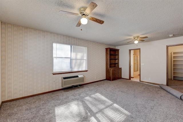 unfurnished bedroom with a wall mounted air conditioner, ceiling fan, a spacious closet, light colored carpet, and a closet