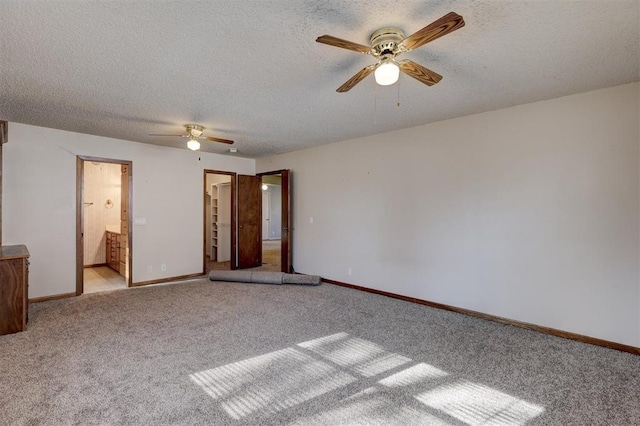 unfurnished bedroom featuring ceiling fan, light carpet, and ensuite bath