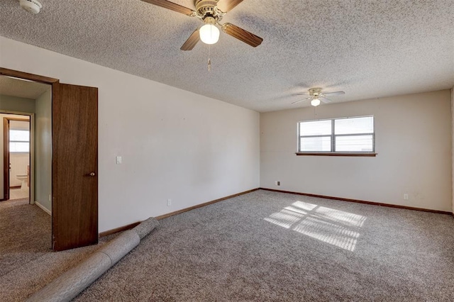 carpeted spare room featuring ceiling fan and a textured ceiling