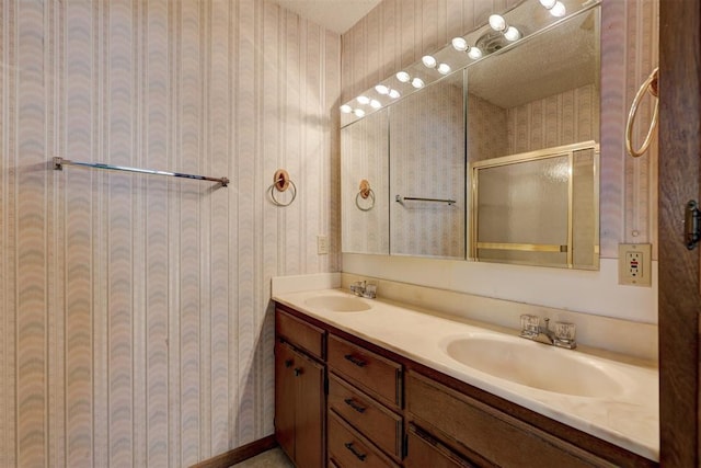 bathroom featuring vanity and a shower with shower door