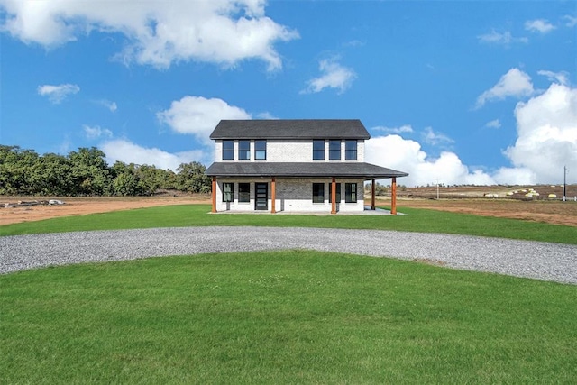 view of front of home featuring covered porch and a front yard