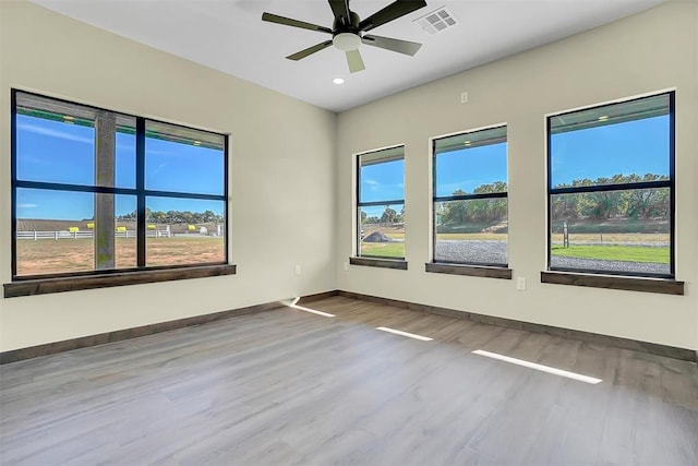 unfurnished room featuring hardwood / wood-style floors and ceiling fan