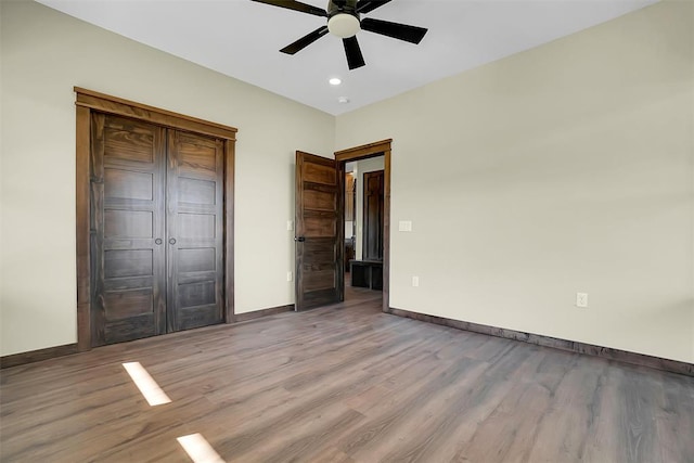 unfurnished bedroom with light hardwood / wood-style flooring and ceiling fan