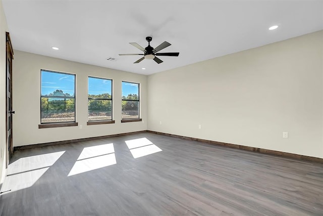 empty room with ceiling fan and wood-type flooring