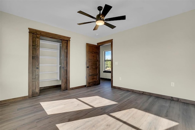 unfurnished bedroom with ceiling fan, a closet, and wood-type flooring