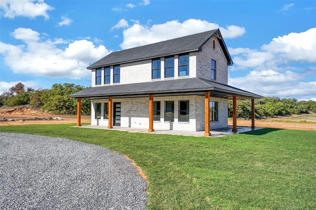 country-style home with a front lawn and a patio