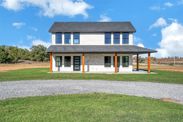 rear view of property with a patio area and a yard