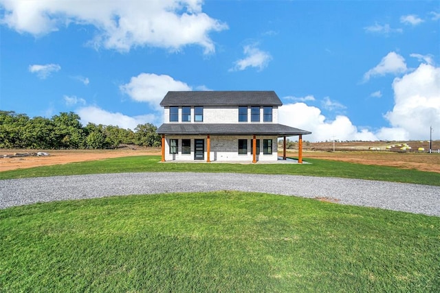 view of front of property featuring covered porch and a front lawn