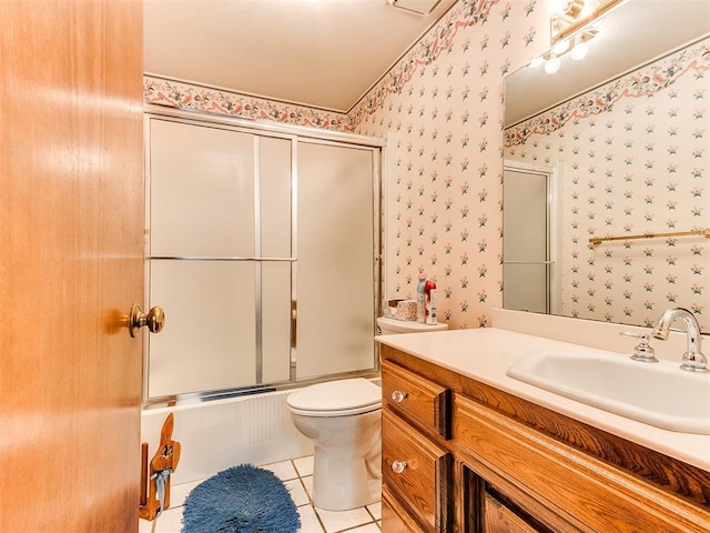 full bathroom featuring tile patterned flooring, vanity, toilet, and enclosed tub / shower combo