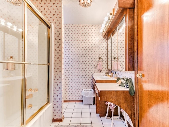 bathroom featuring tile patterned floors, vanity, and shower / bath combination with glass door