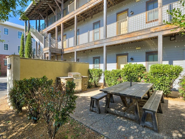 view of patio featuring grilling area and a balcony