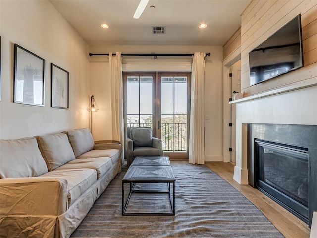 living room featuring ceiling fan and hardwood / wood-style floors