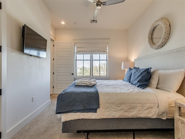 bedroom with ceiling fan and light colored carpet