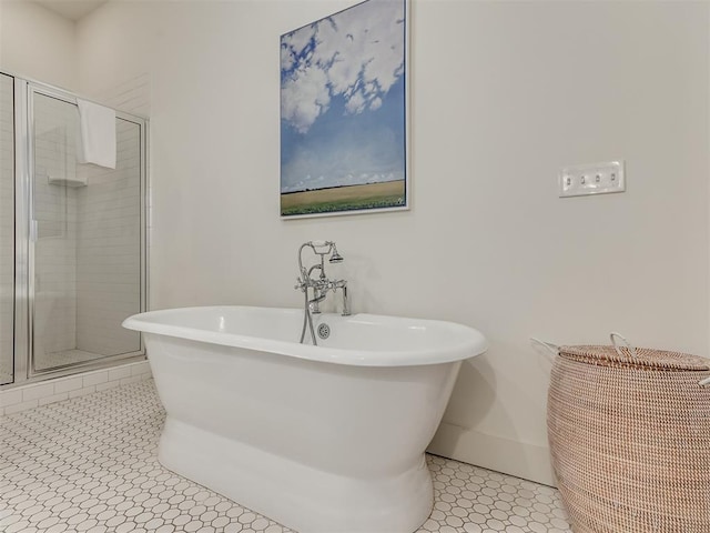 bathroom featuring tile patterned flooring and separate shower and tub