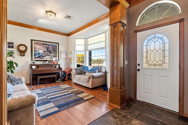 foyer with a textured ceiling, crown molding, and dark hardwood / wood-style floors