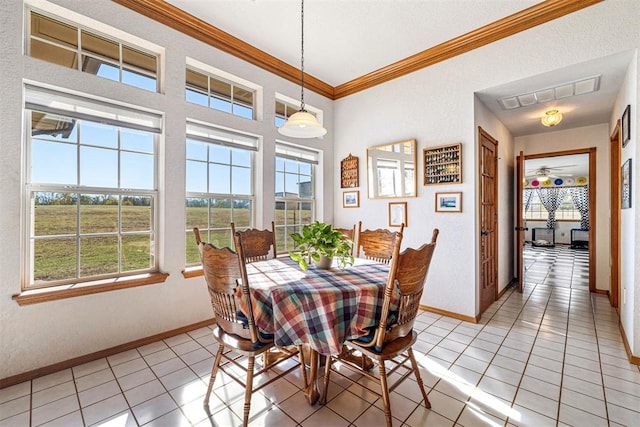 dining area with light tile patterned floors, crown molding, and a healthy amount of sunlight