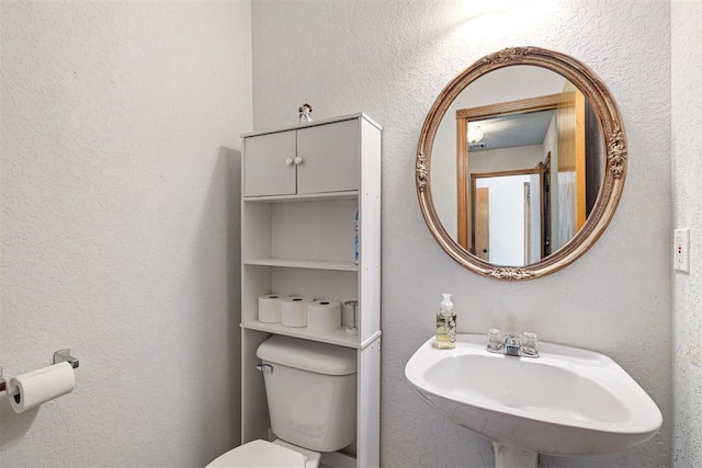 bathroom with toilet and sink