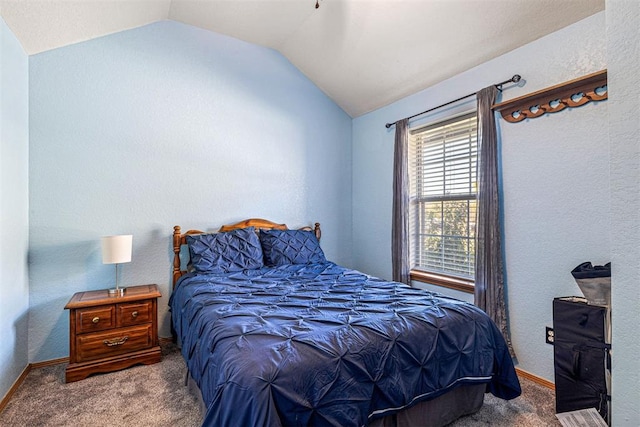 carpeted bedroom with vaulted ceiling