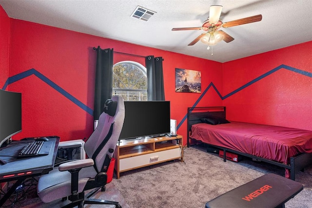 bedroom with carpet, a textured ceiling, and ceiling fan