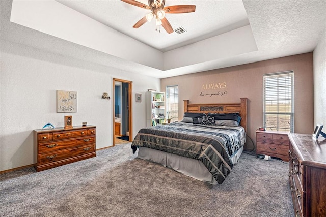 bedroom featuring carpet flooring, a textured ceiling, ensuite bathroom, and ceiling fan