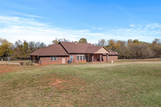 exterior space featuring central AC unit and a front yard