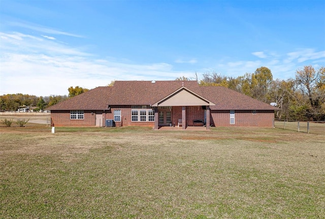 view of front of property with a front lawn and cooling unit