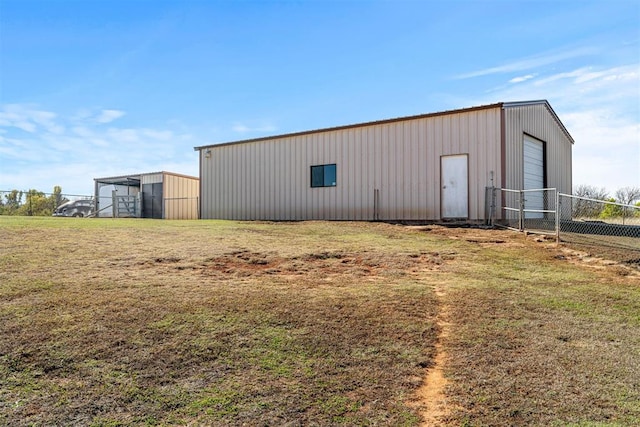 view of outdoor structure featuring a yard and a garage