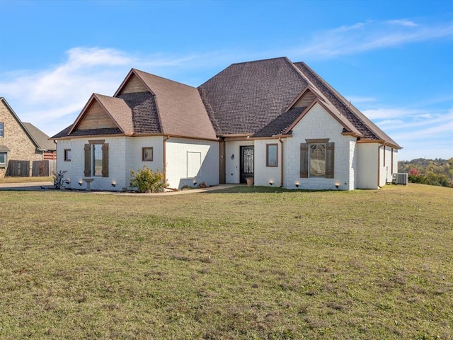 view of front of property featuring central AC unit and a front yard