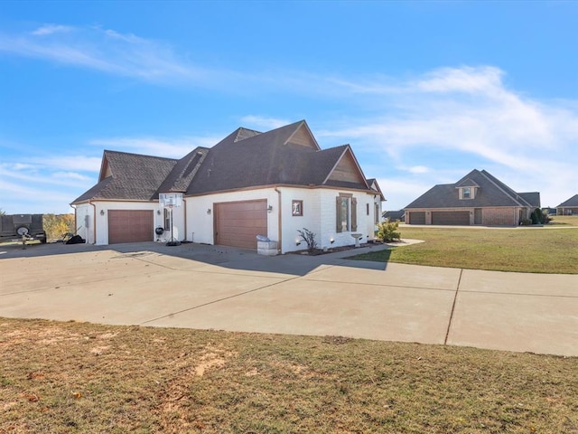 view of side of home featuring a lawn and a garage