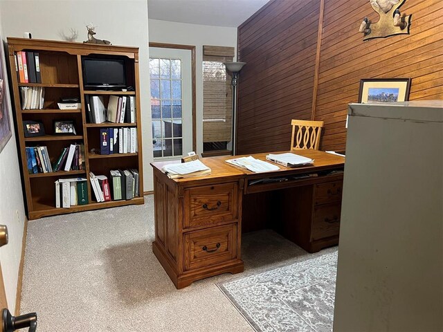 office space featuring light colored carpet and wood walls