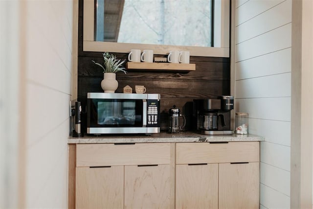 bar featuring light brown cabinets